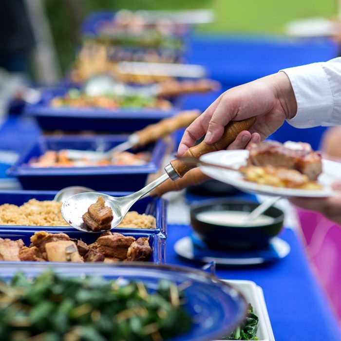group in the line catering buffet food indoor in luxury restaurant with meat colorful rice and vegetables