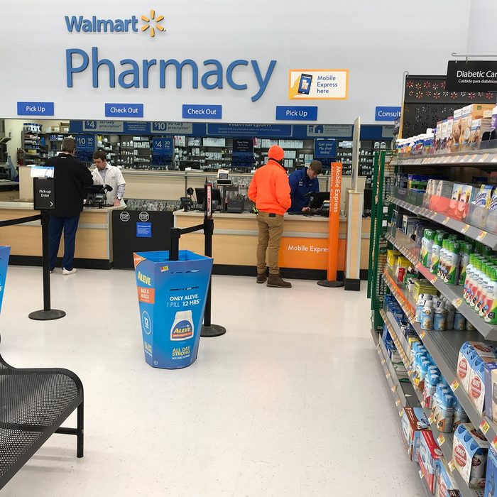 Two customers pick up their orders at a Walmart pharmacy in Minnesota.