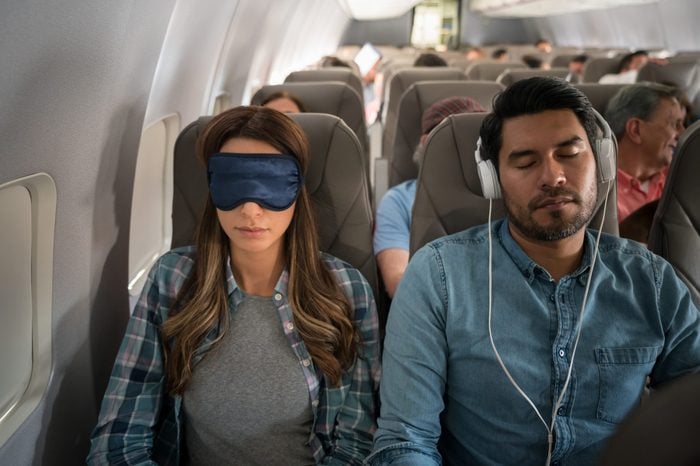 People traveling by air and sleeping on the plane