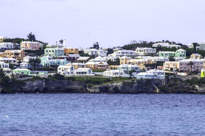 Arriving at the Island of Bermuda we see Colorful Homes on a hillside overlooking the Atlantic Ocean