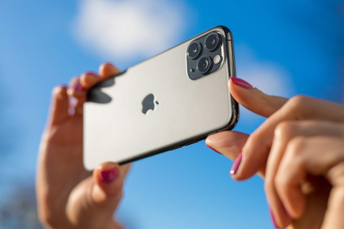apple iphone 11. womans hands holding phone horizontally.