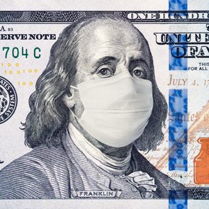 American President with face mask against CoV infection. 100 dollar banknote. Coronavirus in United States. Concept quarantine and recession. Global economy hit by corona virus outbreak and pandemic