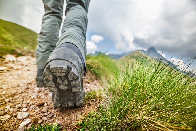 Hiker walks on Mountain Trail