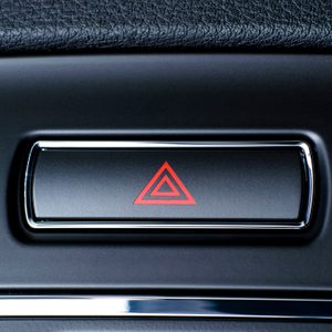 Vehicle, car hazard warning flashers button with visible red triangle.