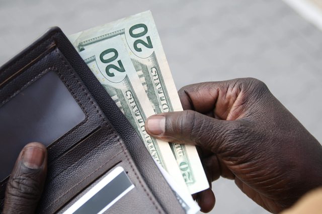 African-American businessman gets money from the wallet