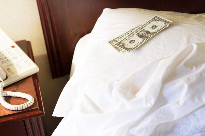 money on a hotel bed