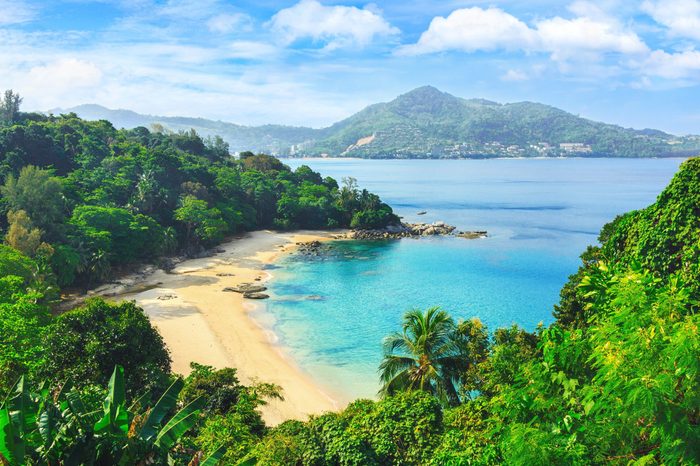 Picturesque view of Andaman sea in Phuket island, Thailand. View through the jungle on the beautiful bay and mountains. Tropical beach Laem Singh.