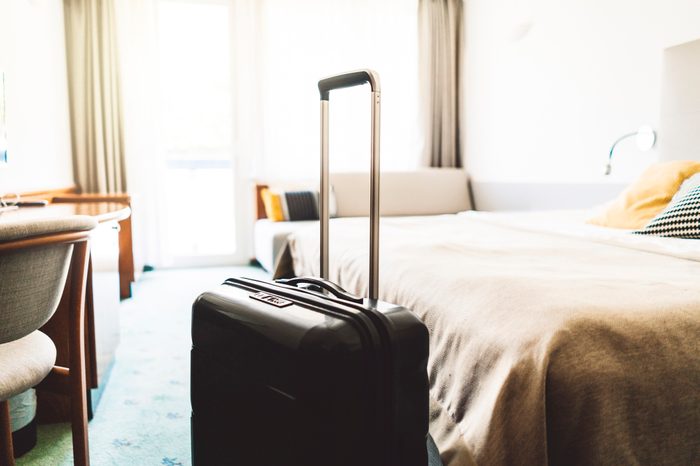 Suitcase in a large empty hotel room