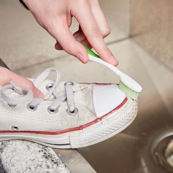 HH clean sneakers with a toothbrush and toothpaste white