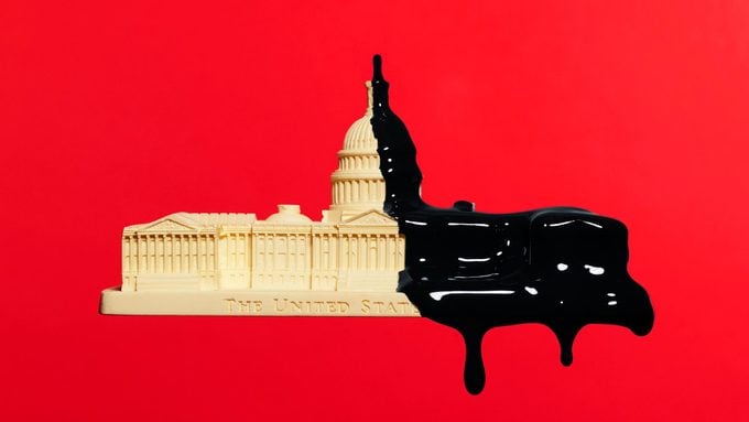 capitol building dripping with black paint on red background
