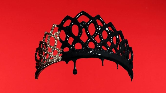 pageant tiara dripping with black paint on red background