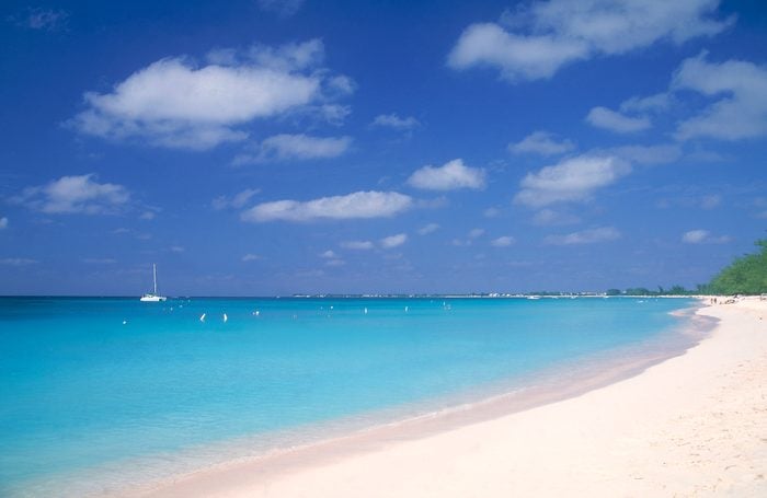 White sand beach with with blue water and skies, Seven Mile Beach, Grand Cayman Island