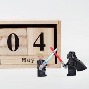 perpetual calendar May 04 and star wars lego figurines on gray background