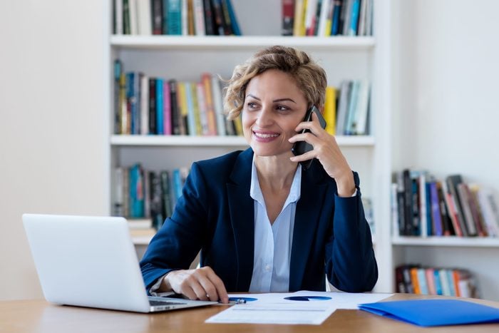 Mature businesswoman talking with client at phone