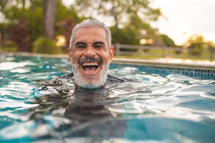 Senior man laughing in the pool