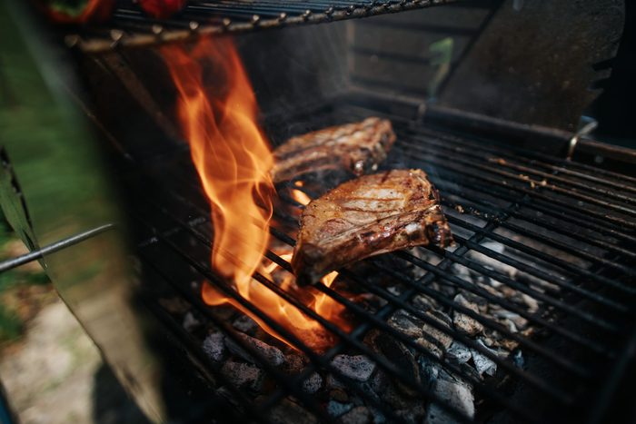 Two Iberico Steaks On A Grill With High Flame