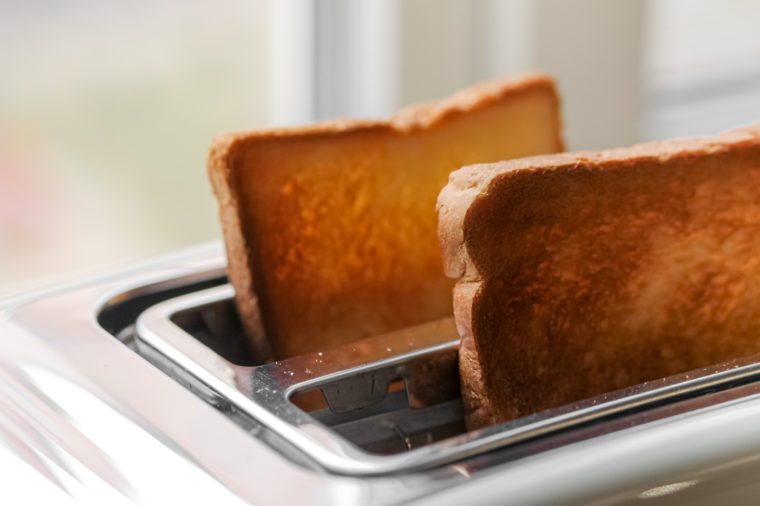 Toaster with ready bread slices in the kitchen. traditional breakfast at home