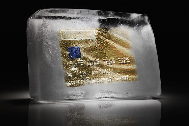 Credit card frozen inside a block of ice