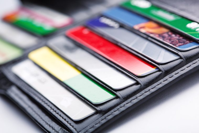 Close-up of open wallet with many credit cards in slots