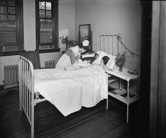 Nurse Bringing Newborn Infant to Mother in Hospital Room, Garfield Hospital, Washington, DC, 1921