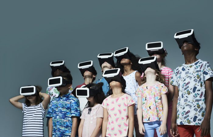 Group of children wearing virtual reality headsets