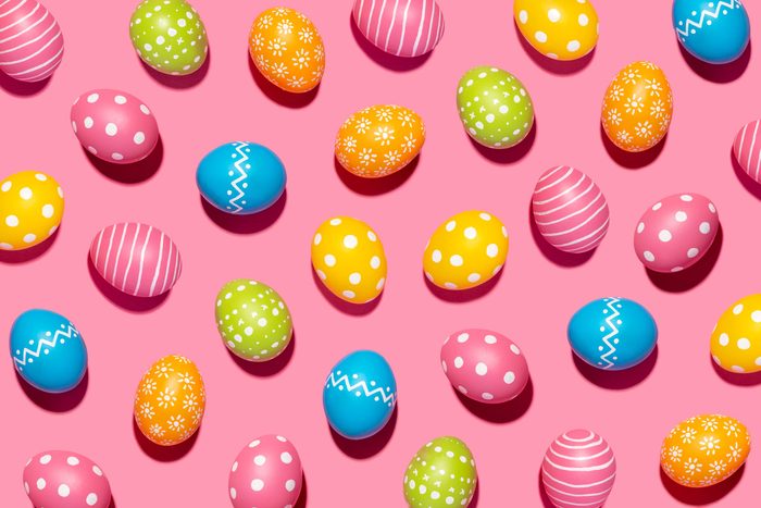 colorful decorated Easter eggs on pink background