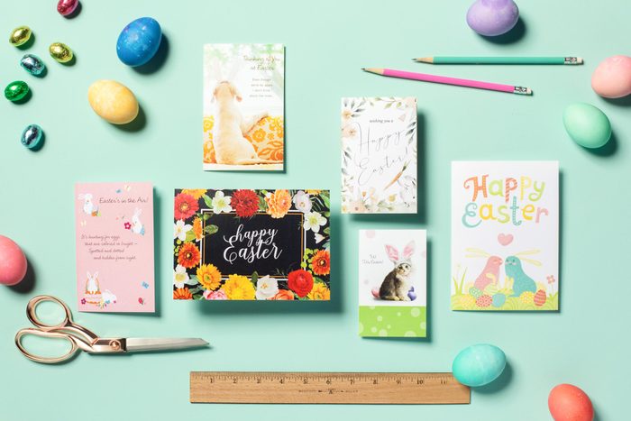 Free Printable Easter Cards arranged on a teal background with easter eggs, candy, pencils, scissors, and a ruler