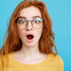 Portrait Of Shocked Woman Against Blue Background