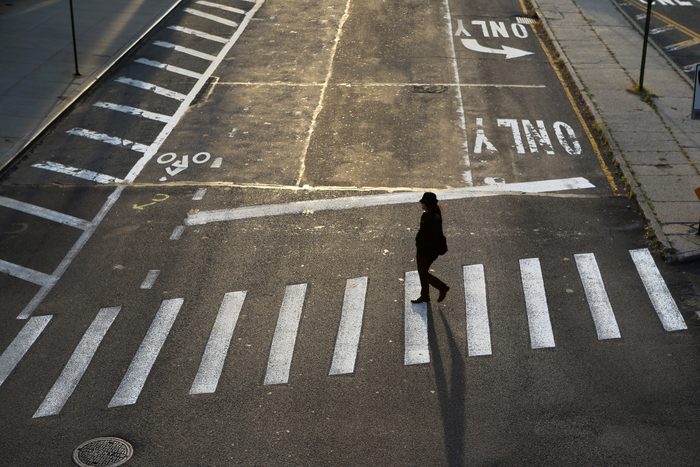 A woman crossing a street in Dumbo, Brooklyn, New York City, USA