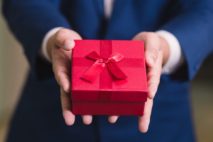 Businessman holding the red gift box