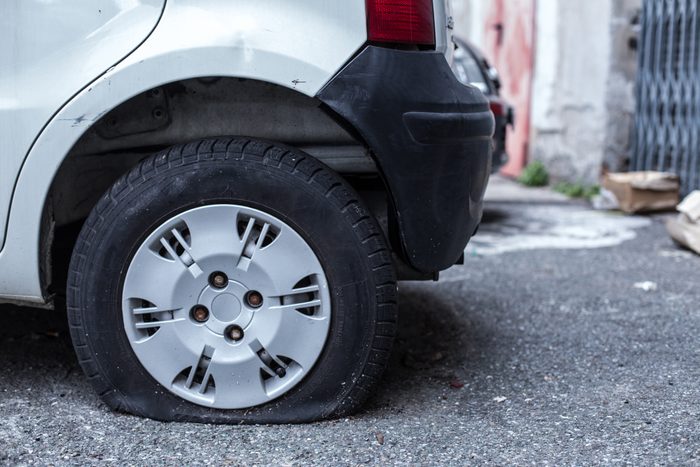 Close-Up Of Car With Puncture Tire