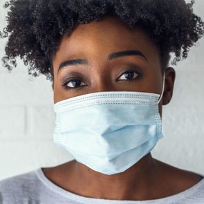 Young African Woman Wearing A Surgical Face Mask