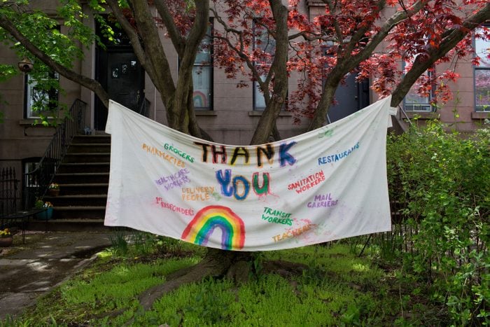 A hand painted sign thanking all essential workers during the COVID-19 pandemic decorates a front lawn on May 3, 2020 in the Carroll Gardens neighborhood of Brooklyn, New York.