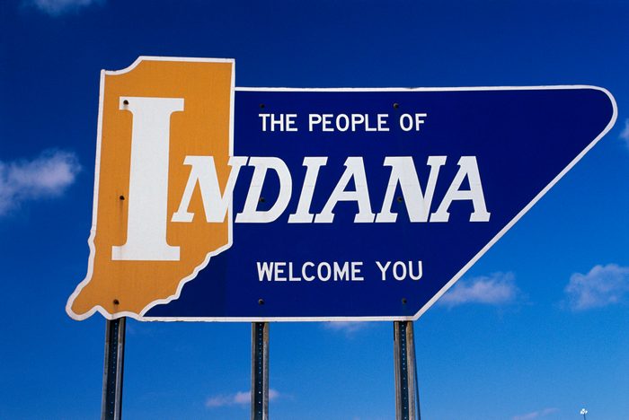 Road sign that says the people of Indiana welcome you