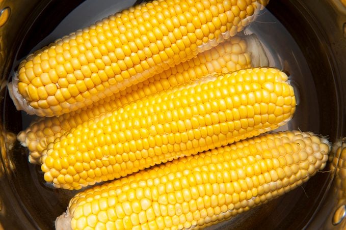 Corn cobs boiling in the water