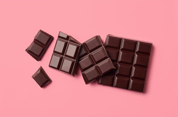 Dark chocolate on pink background