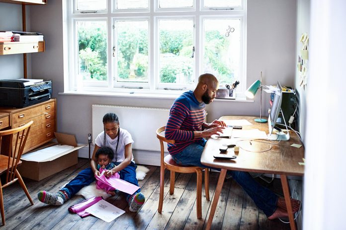 Parents with baby son working at home