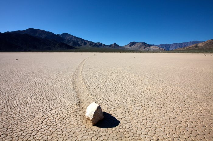 Rock and track in Racetrack Playa, Death Valley National Park, California, USA