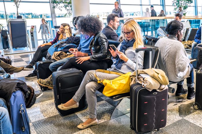 crowded passenger waiting lounge area in an airport