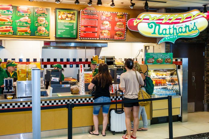 Nathan's Famous fast food hot dogs concession counter inside Miami International Airport.