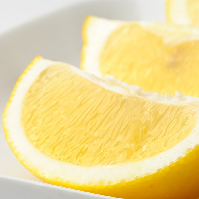 Lemon wedges in a white dish