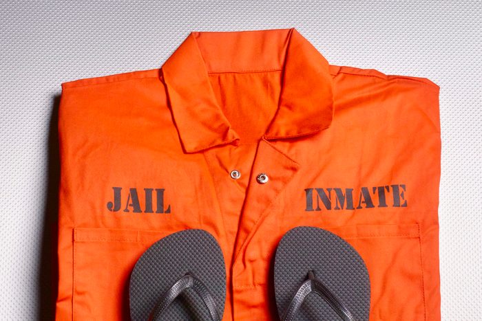 Orange jump suit in prison cell
