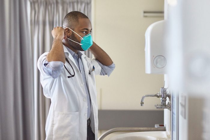 Young doctor wearing surgical mask in hospital