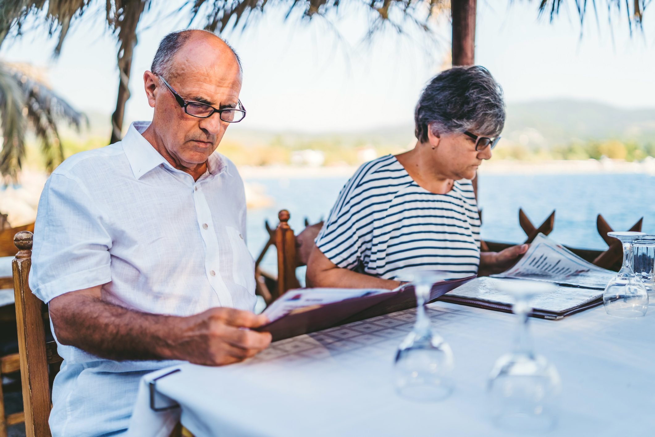 Senior couple looking at restaurant menu
