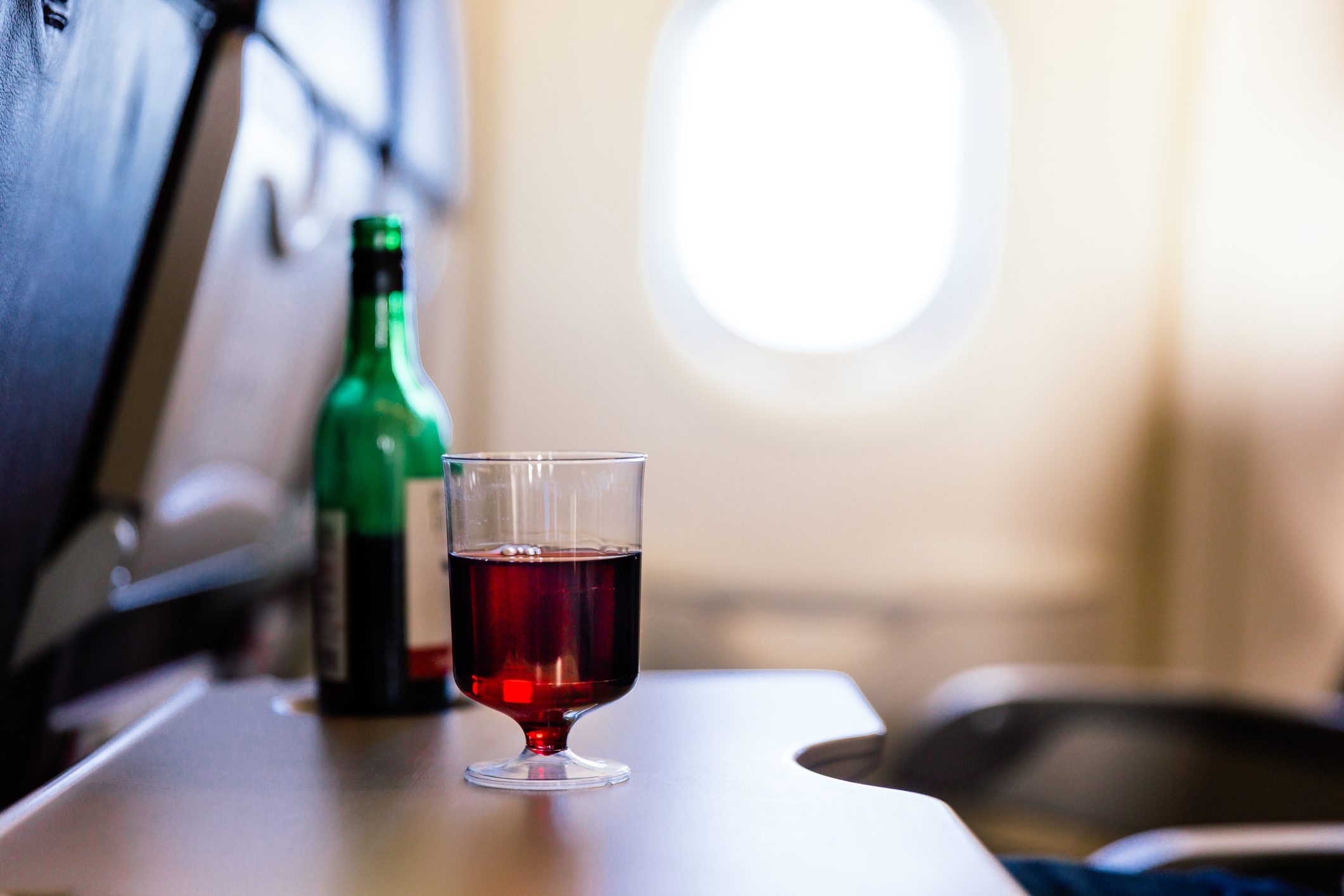 Plastic cup of red wine in the airplane