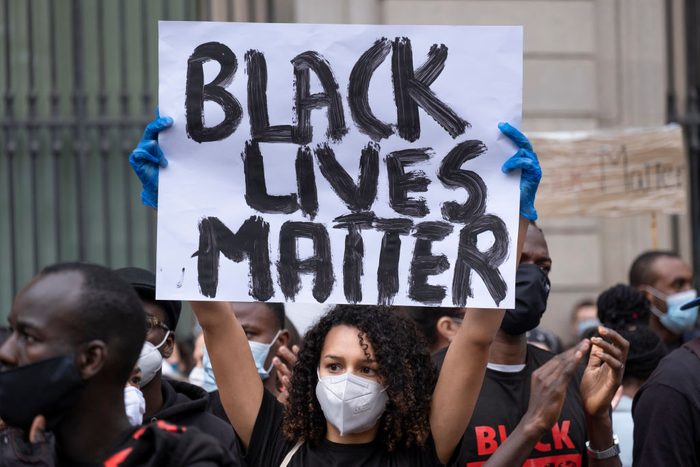 A protester holds a placard saying Black Lives Matter during...