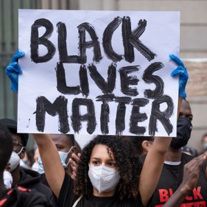 A protester holds a placard saying Black Lives Matter during...