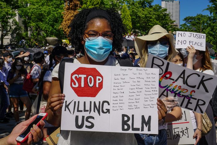 A protester holding a BLM placard during the demonstration.