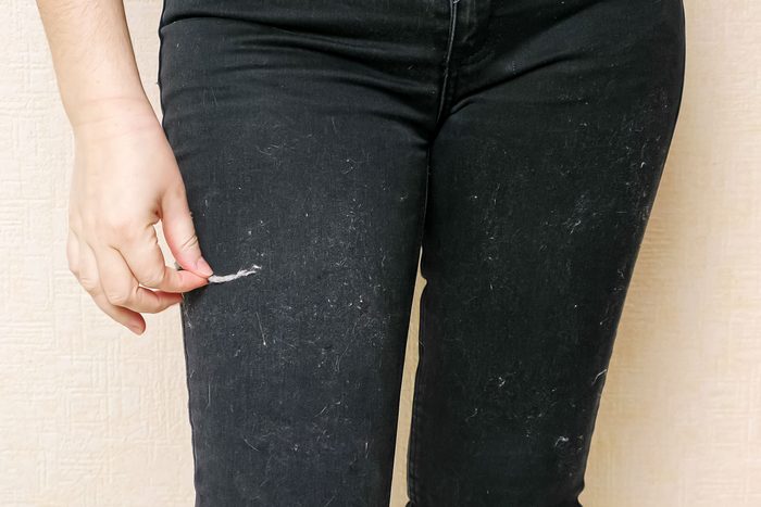 woman with lint on black pants