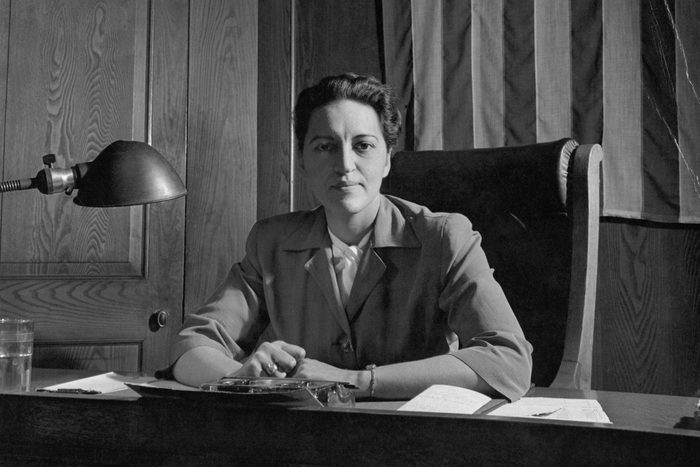 Justice Jane M. Bolin seated at her desk under an American flag